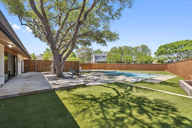 view of yard with a fenced in pool, a fenced backyard, and a patio