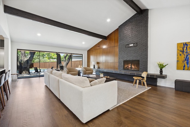 living area with recessed lighting, dark wood finished floors, beam ceiling, a fireplace, and high vaulted ceiling