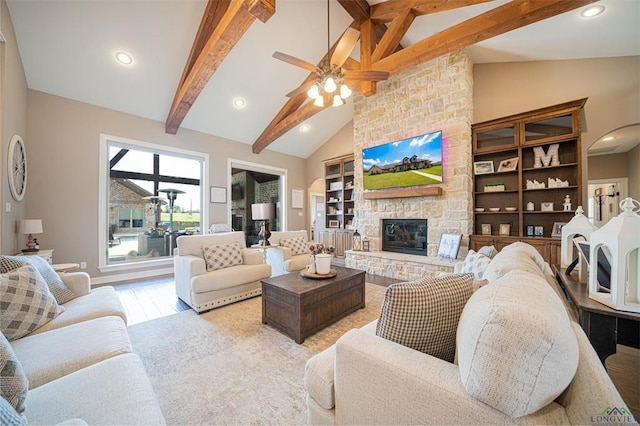 225 Clements Cir, Tatum, TX 75691 - living room with recessed lighting, a stone fireplace, light wood-type flooring, lofted ceiling with beams, and ceiling fan