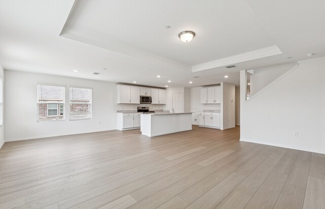 7200 Pederson Creek Way, Denton, TX 76208 - unfurnished living room with a tray ceiling, light wood-type flooring, recessed lighting, ornamental molding, and baseboards