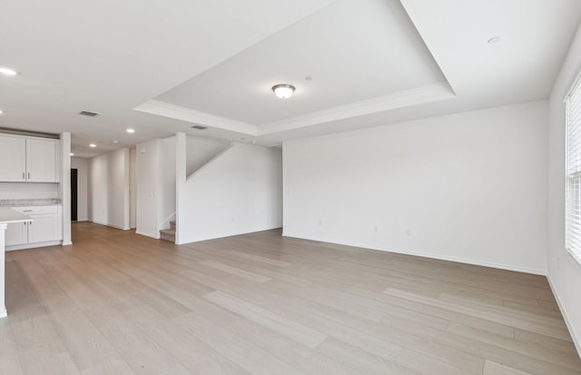 7200 Pederson Creek Way, Denton, TX 76208 - unfurnished living room featuring a raised ceiling, light wood-style floors, stairs, ornamental molding, and recessed lighting