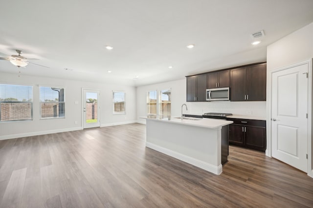 kitchen with a sink, open floor plan, visible vents, ceiling fan, and appliances with stainless steel finishes