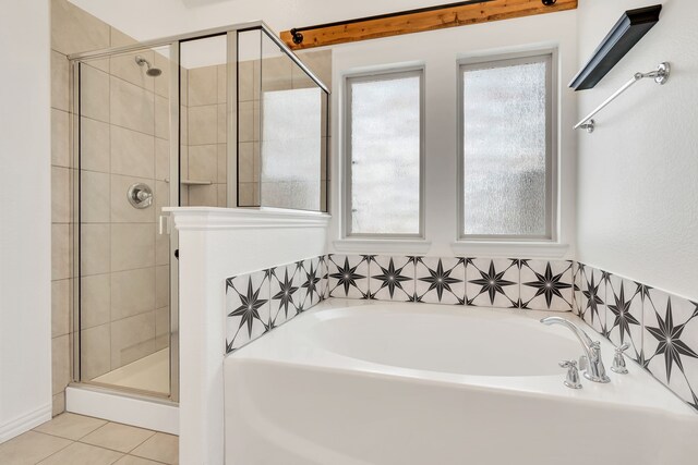 full bathroom featuring a stall shower, a garden tub, and tile patterned flooring