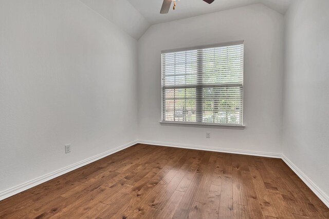 empty room with dark wood finished floors, ceiling fan, lofted ceiling, and plenty of natural light