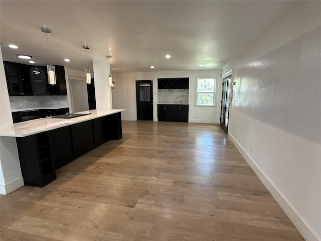 kitchen with dark cabinets, baseboards, recessed lighting, and tasteful backsplash