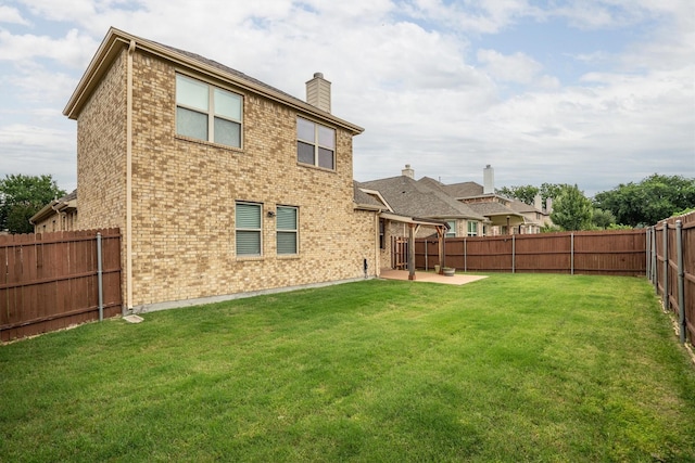 4717 Whitehall Ct, Mckinney, TX 75070 - rear view of house with brick siding, a chimney, and a patio