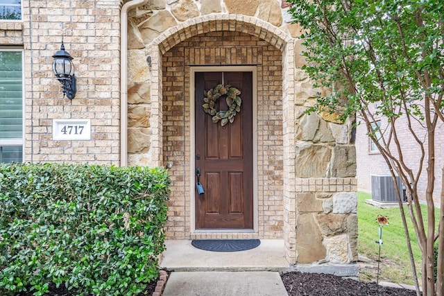 4717 Whitehall Ct, Mckinney, TX 75070 - entrance to property with brick siding, central air condition unit, and stone siding