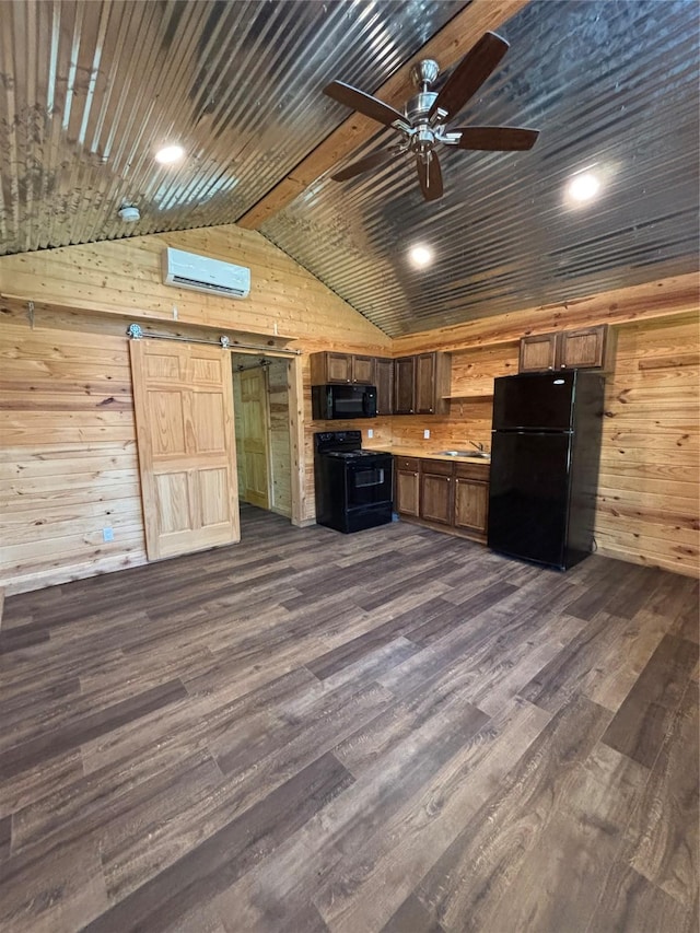 kitchen featuring black appliances, wood walls, vaulted ceiling, and ceiling fan