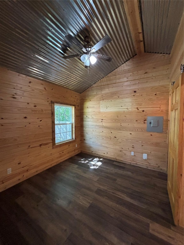 unfurnished room featuring vaulted ceiling, wooden walls, ceiling fan, wooden ceiling, and dark wood finished floors
