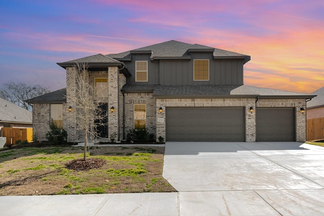 view of front of house with concrete driveway, fence, brick siding, an attached garage, and a shingled roof