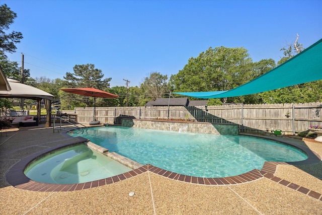 view of swimming pool featuring a patio, a fenced backyard, and a pool with connected hot tub