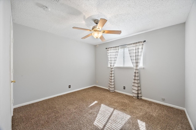 empty room with carpet floors, a textured ceiling, a ceiling fan, and baseboards