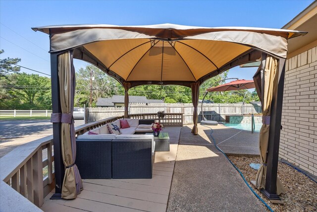view of patio / terrace featuring an outdoor hangout area, a fenced backyard, a gazebo, and a fenced in pool