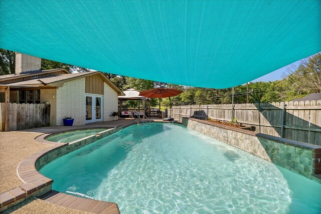 view of pool featuring a gazebo, french doors, and a fenced backyard