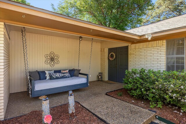 property entrance featuring brick siding and an outdoor hangout area