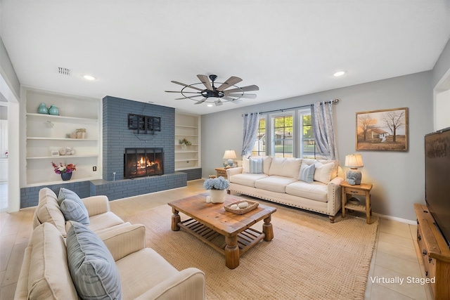 living area with light tile patterned flooring, built in features, recessed lighting, a ceiling fan, and a brick fireplace