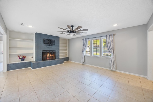 unfurnished living room featuring recessed lighting, a brick fireplace, built in shelves, a ceiling fan, and tile patterned flooring