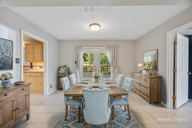 dining room with baseboards, french doors, visible vents, and light tile patterned flooring
