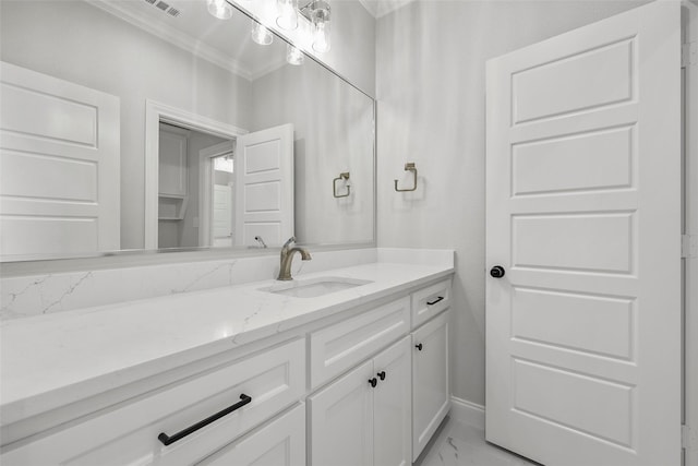 bathroom featuring visible vents, baseboards, marble finish floor, vanity, and ornamental molding