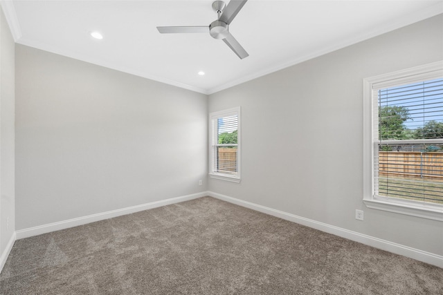unfurnished room with carpet floors, a ceiling fan, baseboards, and ornamental molding