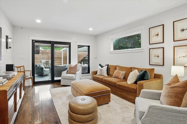 living room with recessed lighting, a wealth of natural light, and wood finished floors