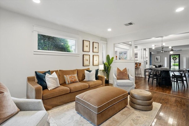 living room featuring recessed lighting, visible vents, a chandelier, and wood finished floors