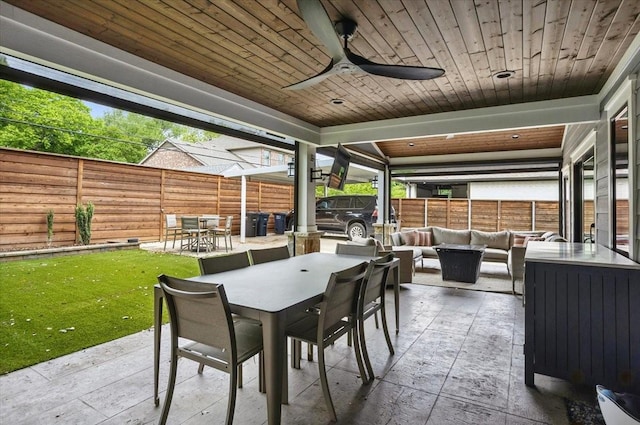 view of patio with outdoor lounge area, ceiling fan, outdoor dining area, and a fenced backyard