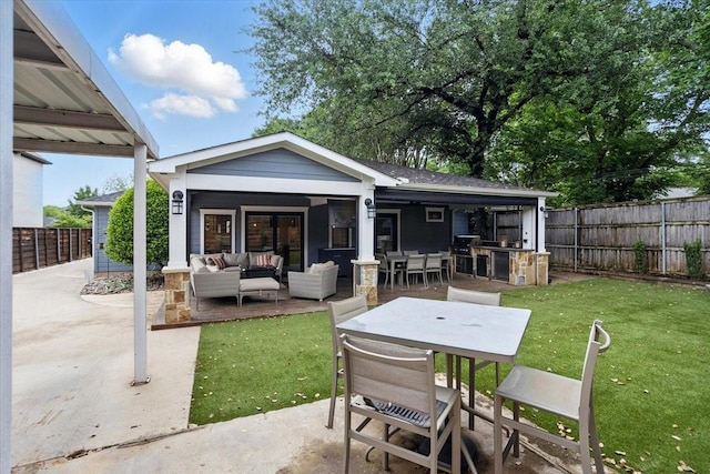 exterior space featuring a patio, an outdoor living space, and a lawn