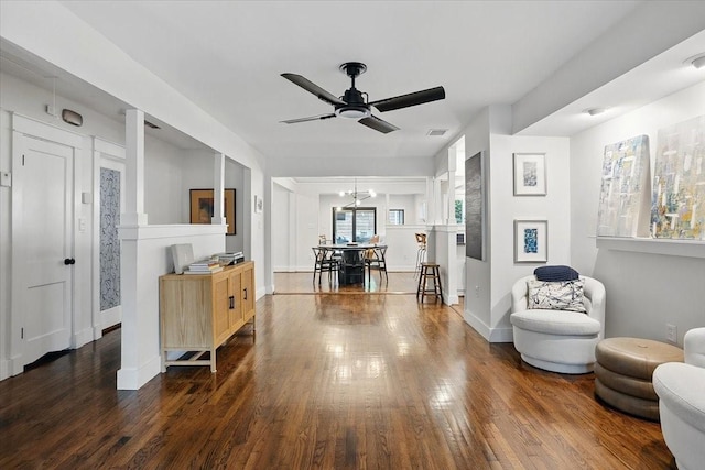 sitting room featuring dark wood-style floors, visible vents, ceiling fan, and baseboards
