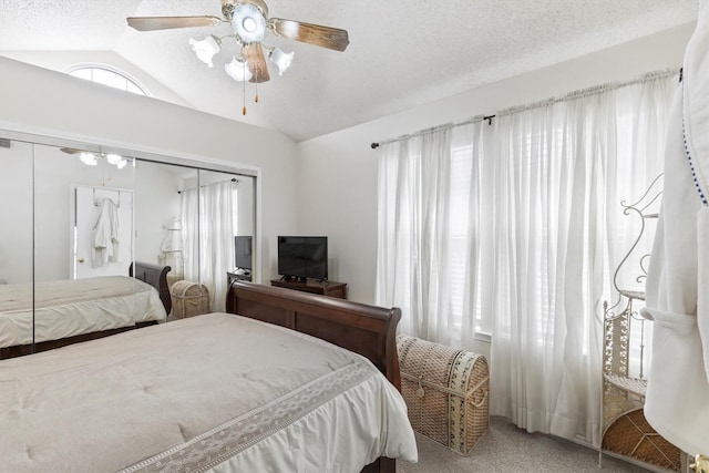 bedroom featuring carpet flooring, a textured ceiling, multiple windows, and lofted ceiling