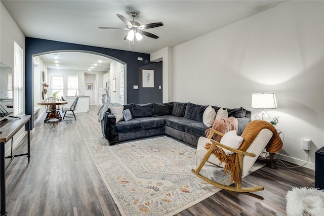 3504 Periwinkle Dr, Aubrey, TX 76227 - living area with arched walkways, wood finished floors, a ceiling fan, and baseboards