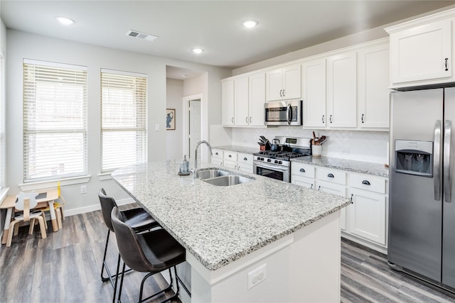 3504 Periwinkle Dr, Aubrey, TX 76227 - kitchen featuring stainless steel appliances, a sink, dark wood-style flooring, white cabinets, and recessed lighting