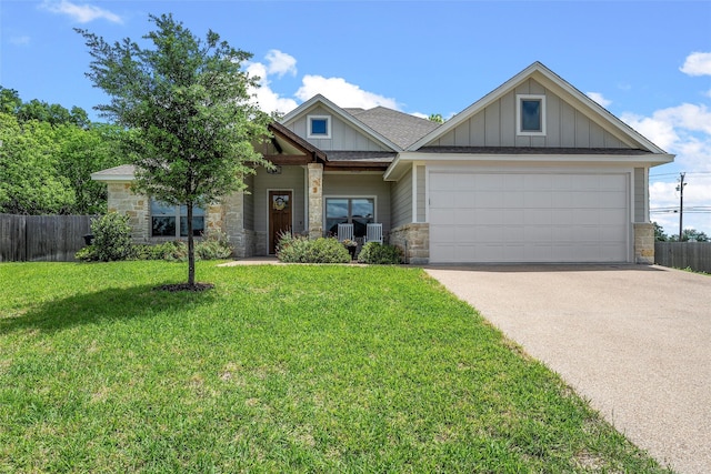 craftsman house with driveway, stone siding, board and batten siding, fence, and a garage