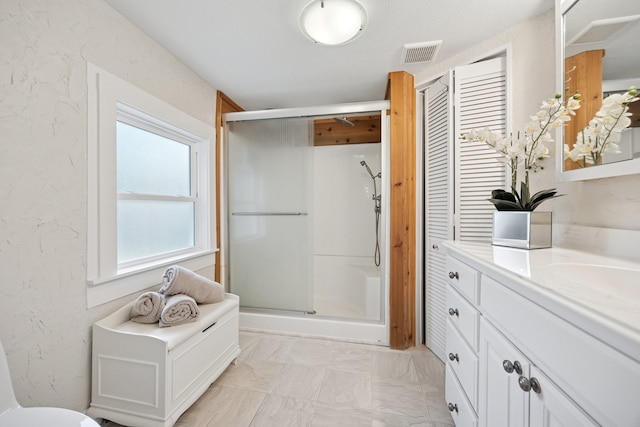 6725 Cahoba Dr, Fort Worth, TX 76135 - bathroom featuring visible vents, a textured wall, vanity, and a shower stall