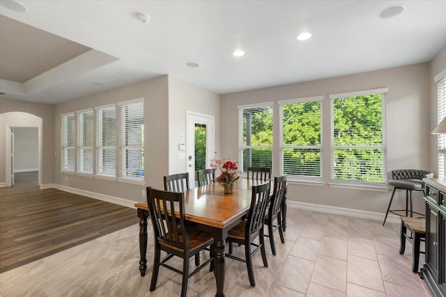6514 Eagle Rock Dr, Frisco, TX 75036 - dining area with baseboards, arched walkways, recessed lighting, and light tile patterned floors