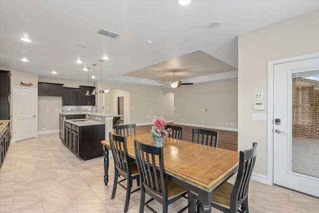 6514 Eagle Rock Dr, Frisco, TX 75036 - dining room with a ceiling fan, arched walkways, baseboards, visible vents, and recessed lighting