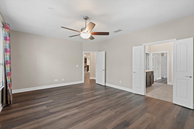6514 Eagle Rock Dr, Frisco, TX 75036 - unfurnished bedroom featuring ensuite bathroom, visible vents, baseboards, wood finished floors, and ceiling fan