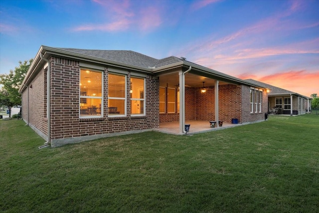 6514 Eagle Rock Dr, Frisco, TX 75036 - back of property with brick siding, a lawn, and a patio