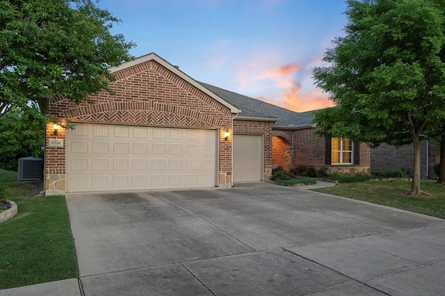 6514 Eagle Rock Dr, Frisco, TX 75036 - ranch-style home featuring central air condition unit, driveway, brick siding, an attached garage, and a lawn