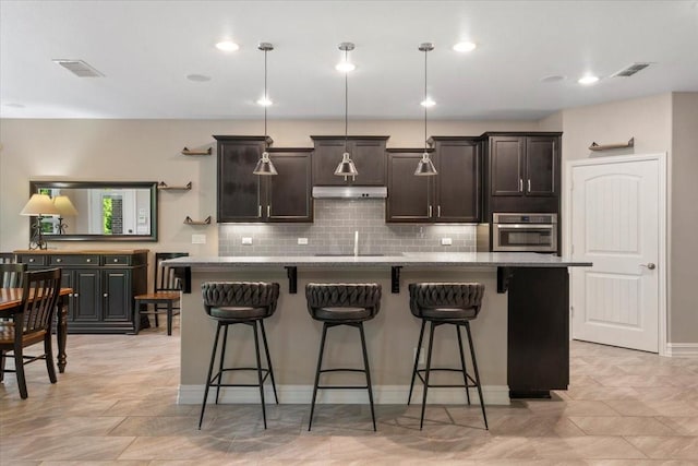 6514 Eagle Rock Dr, Frisco, TX 75036 - kitchen with a breakfast bar, visible vents, oven, and decorative backsplash