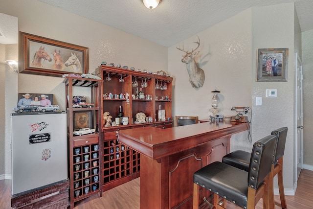 6121 Bowfin Dr, Fort Worth, TX 76179 - bar with wood finished floors, a bar, and baseboards