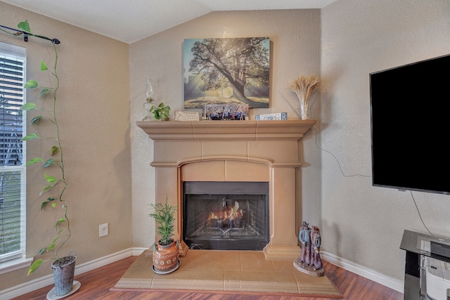 6121 Bowfin Dr, Fort Worth, TX 76179 - interior details with a warm lit fireplace, wood finished floors, and baseboards