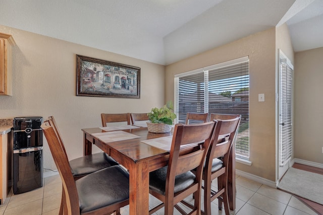 6121 Bowfin Dr, Fort Worth, TX 76179 - dining space featuring baseboards, vaulted ceiling, a healthy amount of sunlight, and light tile patterned floors