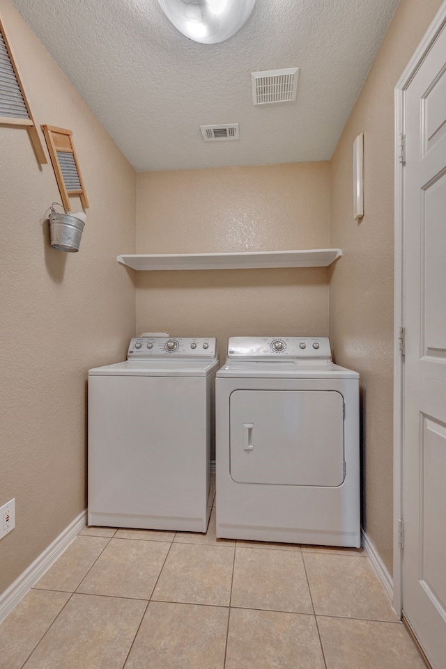 6121 Bowfin Dr, Fort Worth, TX 76179 - laundry room featuring light tile patterned floors, laundry area, visible vents, and independent washer and dryer