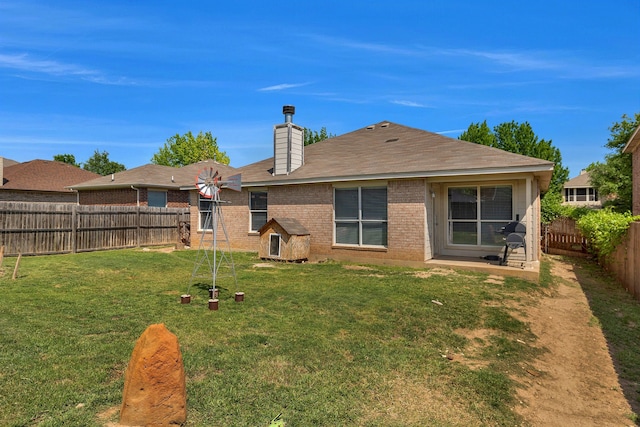 6121 Bowfin Dr, Fort Worth, TX 76179 - rear view of house with a chimney, a shingled roof, a fenced backyard, a yard, and brick siding
