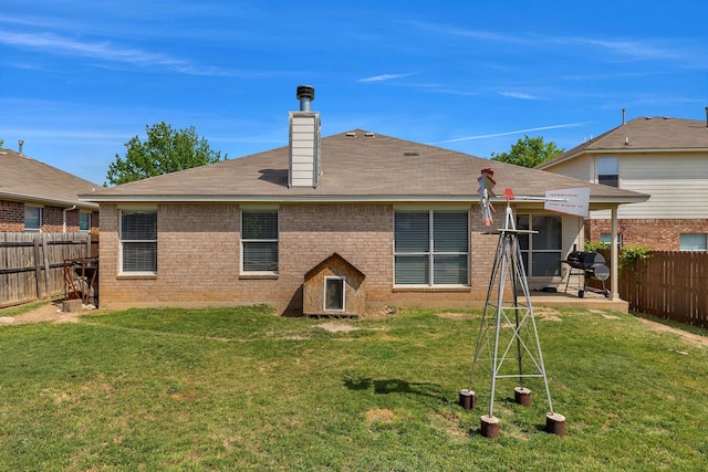 6121 Bowfin Dr, Fort Worth, TX 76179 - rear view of property with brick siding, a lawn, a chimney, and a fenced backyard