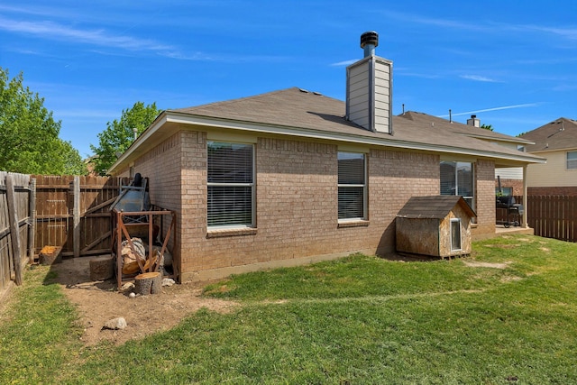 6121 Bowfin Dr, Fort Worth, TX 76179 - rear view of house with a storage shed, a chimney, a lawn, a fenced backyard, and brick siding