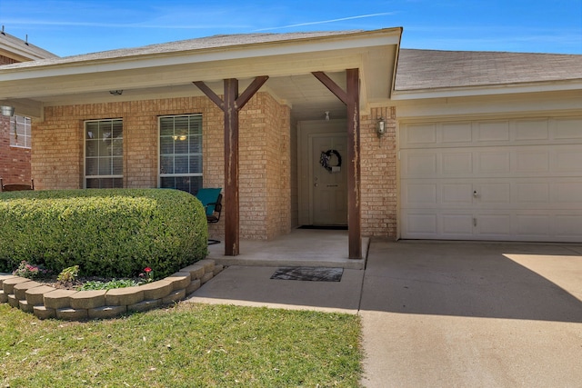 6121 Bowfin Dr, Fort Worth, TX 76179 - doorway to property with an attached garage, brick siding, driveway, and covered porch