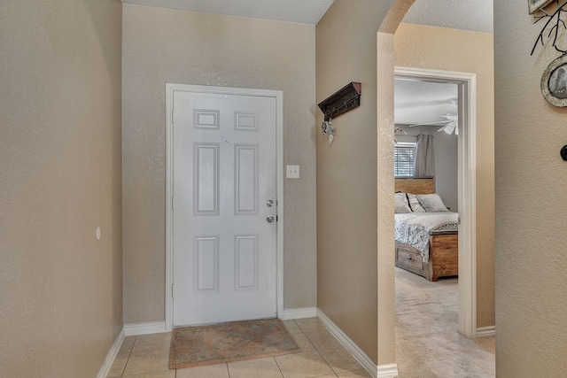 6121 Bowfin Dr, Fort Worth, TX 76179 - entrance foyer with arched walkways, baseboards, and light tile patterned floors