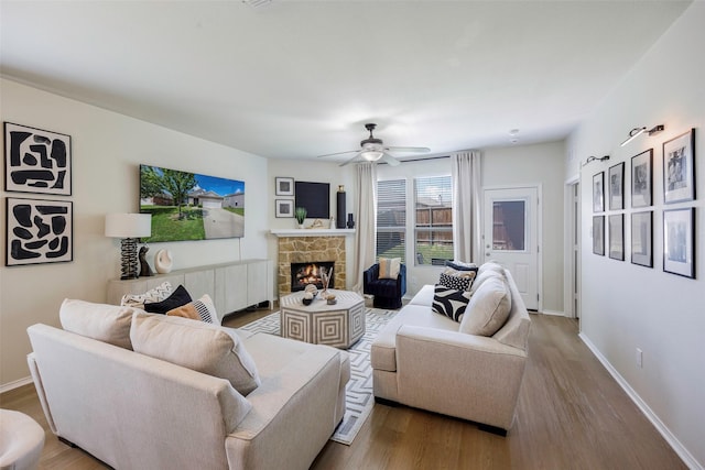 3011 Whispering Pine Blvd, Melissa, TX 75454 - living room featuring wood finished floors, ceiling fan, and a stone fireplace